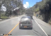 dashcam footage shows a person running as debris flies through the air in the distance at the moment of the explosion that killed over a dozen people in cajibio cauca colombia april 25 2026 reuters
