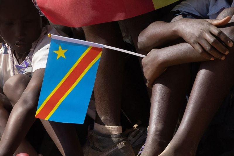 a child holding the flag of dr congo the country is facing mpox and another mysterious flu like disease photo afp