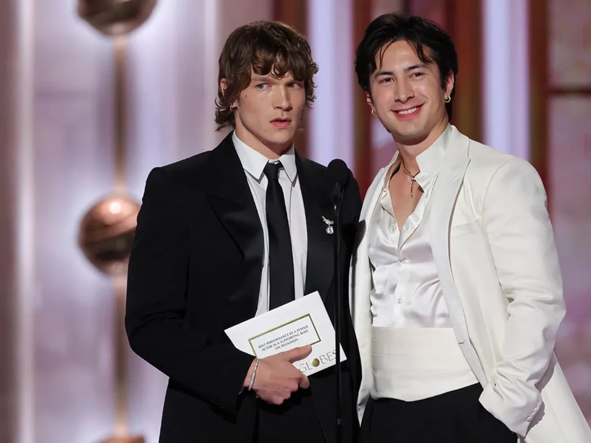 hudson williams and connor storrie carry olympic flame at milano cortina 2026