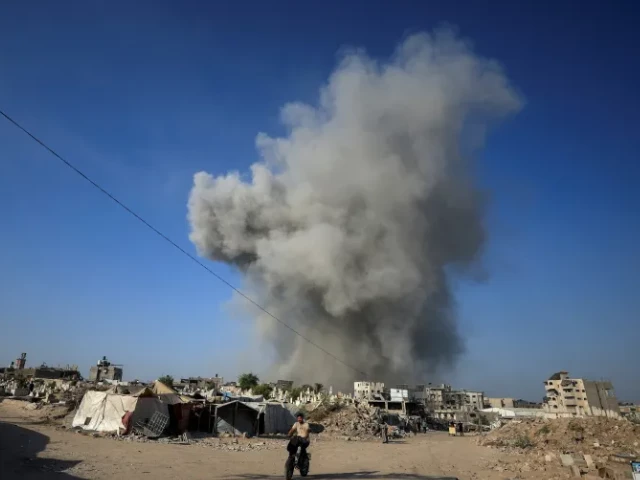 a palestinian man rides a bike as smoke rises following an israeli attack on gaza city august 24 2025 photo reuters a palestinian man rides a bike as smoke rises following an israeli attack on gaza city august 24 2025 photo reuters
