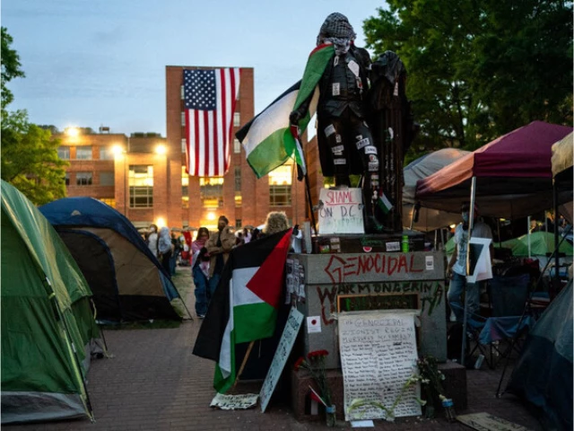people walk around a pro palestinian encampment outside the george washington university law school in washington dc on may 3 2024 photo afp file people walk around a pro palestinian encampment outside the george washington university law school in washington dc on may 3 2024 photo afp file