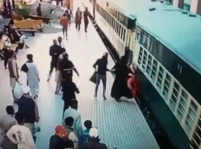 watch railway police officer saves woman from falling under moving train