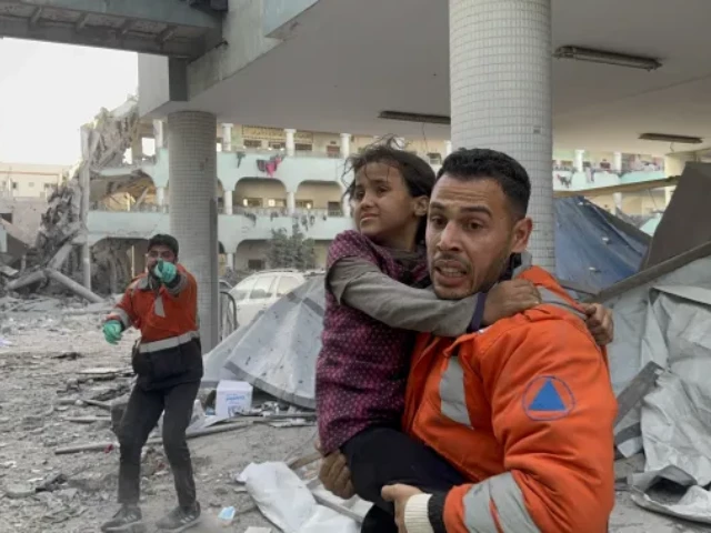 a palestinian child is carried by rescue workers after israel attacked the dar al arqam school turned shelter for displaced people in gaza city on thursday ayman alhesi anadolu a palestinian child is carried by rescue workers after israel attacked the dar al arqam school turned shelter for displaced people in gaza city on thursday ayman alhesi anadolu