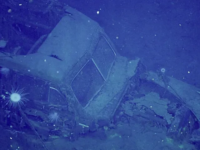 researchers identified the car as a 1940 41 ford super deluxe woody with the words ship service navy written on part of its front plate noaa ocean exploration 2025 beyond the blue