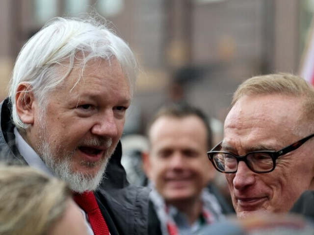 WikiLeaks founder Julian Assange (L) and former Australian minister for foreign affairs Bob Carr (R) chat during a pro-Palestinian rally against Israel’s actions and the ongoing food shortages in the Gaza Strip, in Sydney on August 3. — AFP