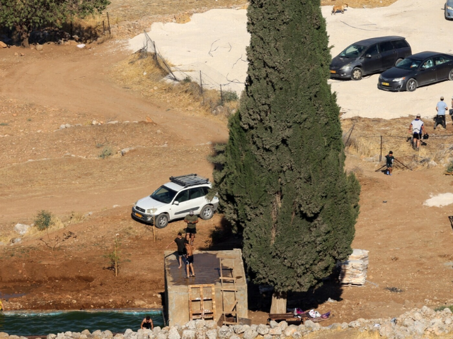 Israeli settlers swim in the Ein Samiyah spring near the village of Kafr Malik, in the Israel-occupied West Bank, on July 15, 2025. — AFP