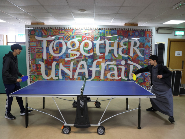 People play table tennis on the day refugees attend a lunch hosted by Khizra Mosque in Manchester as part of its Eid al-Adha celebrations, in Manchester, Britain, June 7, 2025.