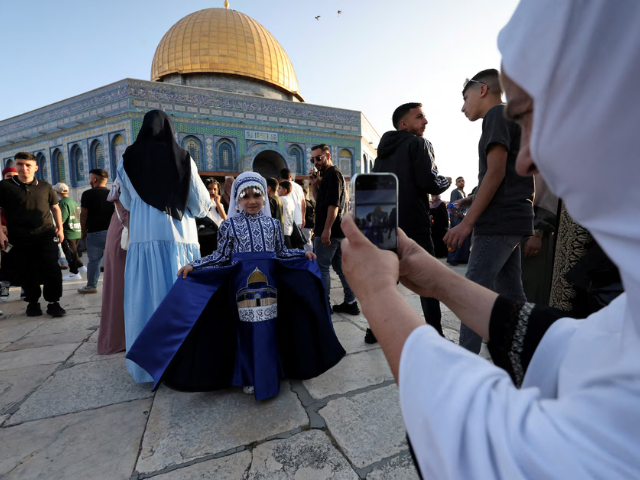 A Palestinian girl in traditional attire poses for a picture, on the first day of the Muslim holiday of Eid al-Adha on the Al-Aqsa compound, also known to Jews as the Temple Mount, in Jerusalem's Old City June 6, 2025. REUTERS/Ammar Awad