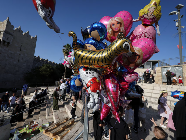 People walk near the Damascus gate on the first day of the Muslim holiday of Eid al-Adha, in Jerusalem's Old City, June 6. REUTERS/Ammar Awad