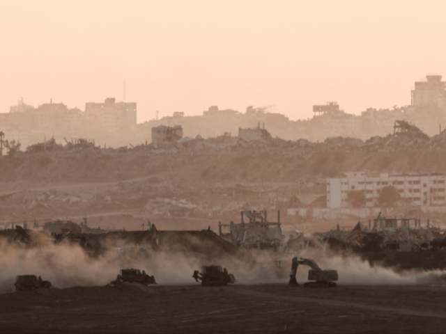 A tank drives near Israeli heavy machinery, as seen from the Israeli side of the Israel-Gaza border on July 13, 2025. — Reuters