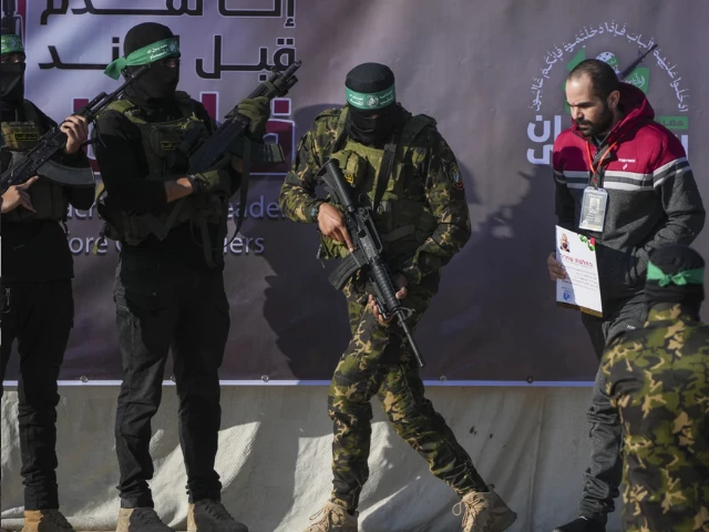 israeli yarden bibas 34 who has been held hostage by hamas in gaza since october 7 2023 is escorted by hamas fighters before being handed over to the red cross in khan younis southern gaza strip saturday feb 1 2025 photo abdel kareem israeli yarden bibas 34 who has been held hostage by hamas in gaza since october 7 2023 is escorted by hamas fighters before being handed over to the red cross in khan younis southern gaza strip saturday feb 1 2025 photo abdel kareem