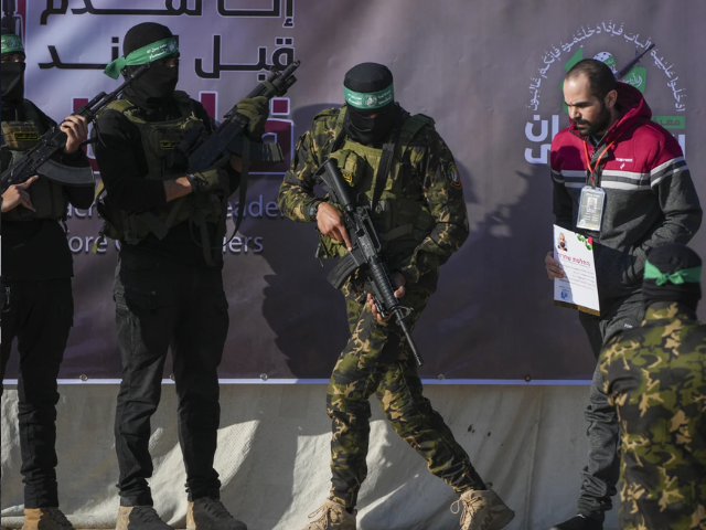 israeli yarden bibas 34 who has been held hostage by hamas in gaza since october 7 2023 is escorted by hamas fighters before being handed over to the red cross in khan younis southern gaza strip saturday feb 1 2025 photo abdel kareem