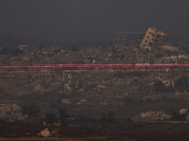 Beams of light are seen from the Israeli side of the Israel-Gaza border on July 10, 2025. — Reuters
