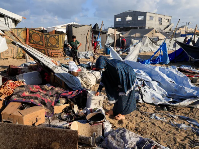 Palestinians inspect the damage at the site of an Israeli strike on a tent sheltering displaced people, in Khan Younis, southern Gaza Strip. Photo-Reuters