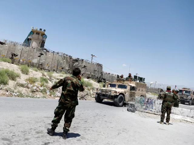 afghan soldiers stand guard at a checkpoint outside the us bagram air base on the day the last of american troops vacated it parwan province afghanistan july 2 2021 photo reuters