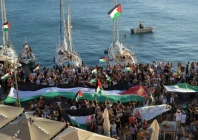 a palestinian flag is seen as people gather at the port of ermoupolis before the departure of two sailing boats electra and oxygen part of the global sumud flotilla aiming to reach gaza and break israel s naval blockade on syros island greece september 14 2025 photo reuters