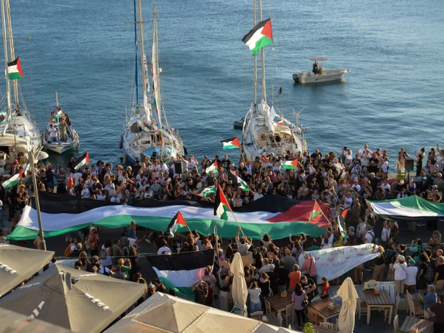a palestinian flag is seen as people gather at the port of ermoupolis before the departure of two sailing boats electra and oxygen part of the global sumud flotilla aiming to reach gaza and break israel s naval blockade on syros island greece september 14 2025 photo reuters