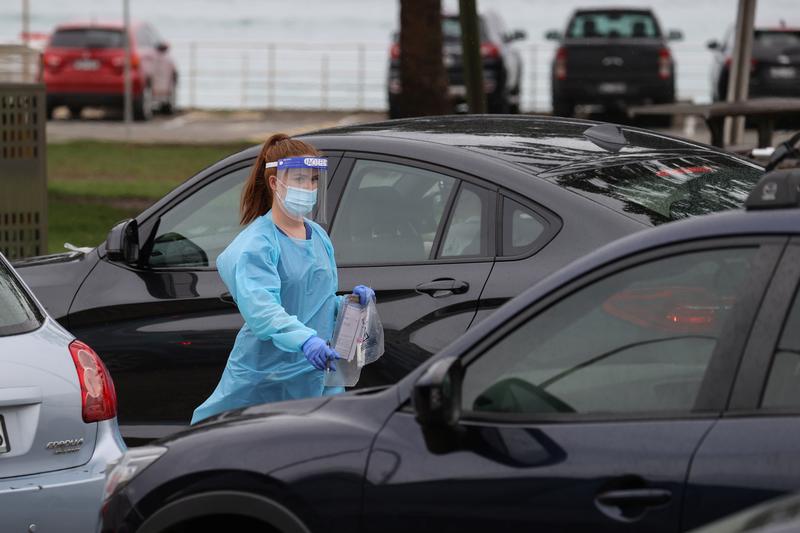 vehicles queue while medical personnel administer tests for the coronavirus disease covid 19 at the bondi beach drive through testing centre as the city experiences an outbreak in sydney australia december 21 2020 photo reuters