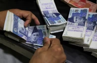 an employee counts pakistani rupee notes at a bank in peshawar on august 22 2023 photo reuters
