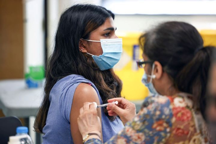 a person receives a dose of the pfizer biontech vaccine at a vaccination centre for those aged over 18 years old at the belmont health centre in harrow amid the coronavirus disease covid 19 outbreak in london britain june 6 2021 reuters henry nicholls