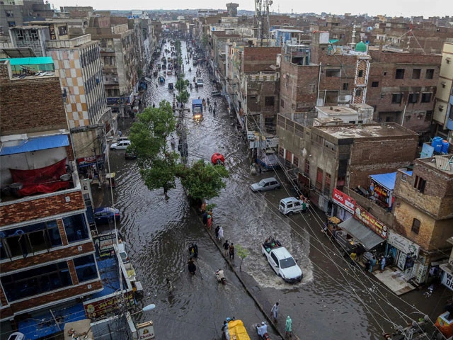 commuters make their way through a flooded street during heavy monsoon rains in hyderabad on july 14 2025 photo afp commuters make their way through a flooded street during heavy monsoon rains in hyderabad on july 14 2025 photo afp