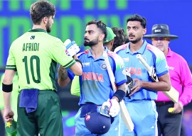 pakistani pacer shaheen shah afridi congratulates indian batsman virat kohli as india s axar patel looks on on their team s victory in the icc champions trophy one day international cricket match at the dubai international stadium photo afp