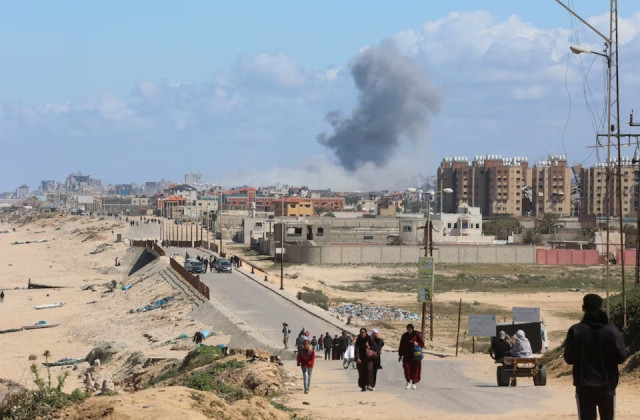 smoke rises following an israeli strike as palestinians fleeing north gaza due to israel s military offensive move southward amid the ongoing conflict between israel and hamas at the central gaza strip march 15 2024 photo reuters