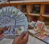 a foreign currency dealer counts us dollars at a shop in karachi pakistan on may 19 2022 photo afp file