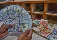 a foreign currency dealer counts us dollars at a shop in karachi pakistan on may 19 2022 photo afp file