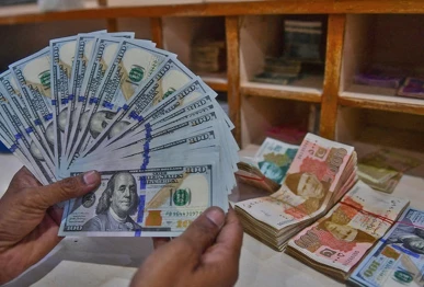 a foreign currency dealer counts us dollars at a shop in karachi pakistan on may 19 2022 photo afp file