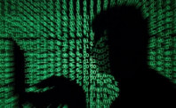 a man holds a laptop computer as cyber code is projected on him in this illustration picture taken on may 13 2017 photo reuters