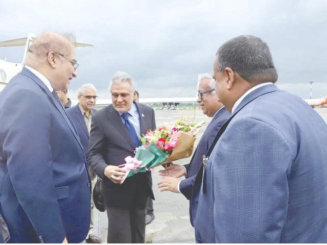 foreign minister ishaq dar holding a bouquet exchanges pleasantries with bangladesh foreign secretary asad alam siam upon his arrival at dhaka airport photo ppi