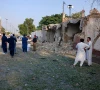 people stand near an ambulance and a damaged section of a police facility following a suicide attack in kohat pakistan september 18 2026 photo reuters