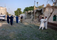 people stand near an ambulance and a damaged section of a police facility following a suicide attack in kohat pakistan september 18 2026 photo reuters