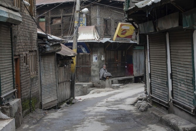 An elderly Kashmiri man sits outside a closed market during a strike in Srinagar, Indian controlled Kashmir, Sunday, Feb. 17, 2019. (Dar Yasin/Photo: Pulitzer.org)