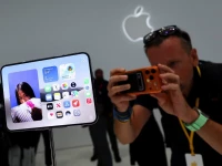 a man records images of the new foldable iphone duo on display during apple s event at the steve jobs theater in cupertino california us september 9 2026 reuters