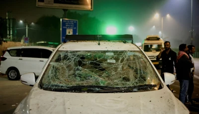 people stand next to a vehicle with its windshield cracked following an explosion in the old quarters of delhi india november 10 2025 photo reuters