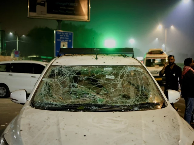 people stand next to a vehicle with its windshield cracked following an explosion in the old quarters of delhi india november 10 2025 photo reuters