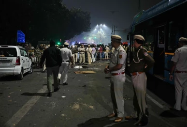 security personnel gather at the blast site after an explosion near the red fort in the old quarters of delhi on november 10 2025 indian fire officers on november 10 reported injuries after fire engulfed several vehicles close to the capital s landmark red fort but the cause of the blaze was not confirmed photo afp