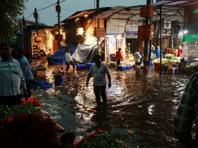 a man wades through a waterlogged street in a wholesale market after rain in new delhi india may 2 2025 reuters a man wades through a waterlogged street in a wholesale market after rain in new delhi india may 2 2025 reuters
