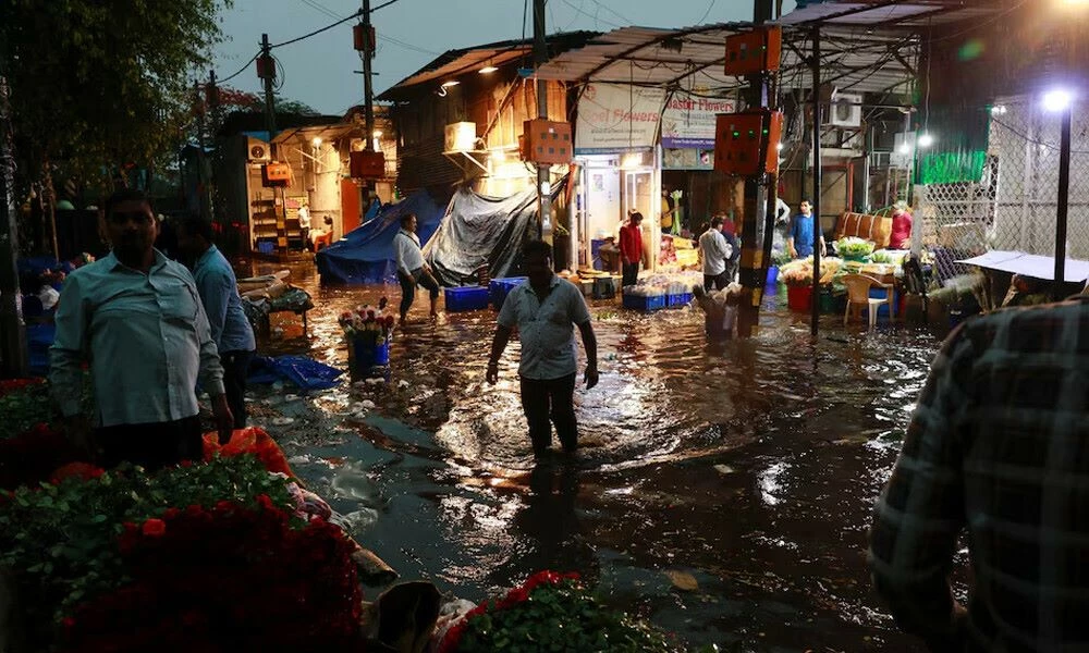 a man wades through a waterlogged street in a wholesale market after rain in new delhi india may 2 2025 reuters a man wades through a waterlogged street in a wholesale market after rain in new delhi india may 2 2025 reuters