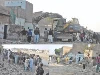authorities demolish illegally constructed houses and shops along the pinyari canal to clear land for new road photo express