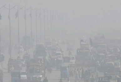 commuters cautiously make their way through a thick blanket of fog on a winter morning as the provincial capital wakes slowly under low visibility turning an ordinary commute into a quiet test of patience and focus photo online