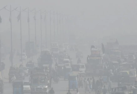 commuters cautiously make their way through a thick blanket of fog on a winter morning as the provincial capital wakes slowly under low visibility turning an ordinary commute into a quiet test of patience and focus photo online