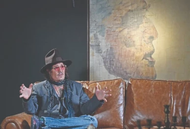 actor johnny depp speaks in front of one of his paintings during an interview after a media preview of his art exhibition in tokyo photo afp