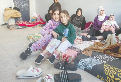 women and children seek refuge in a classroom at a school transformed into a shelter in sidon photo afp