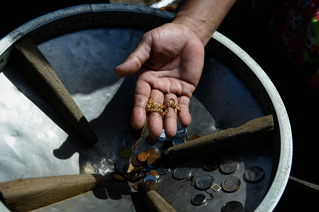 A diver holds jewelry and rare coins he found during diving trips. PHOTO: AFP