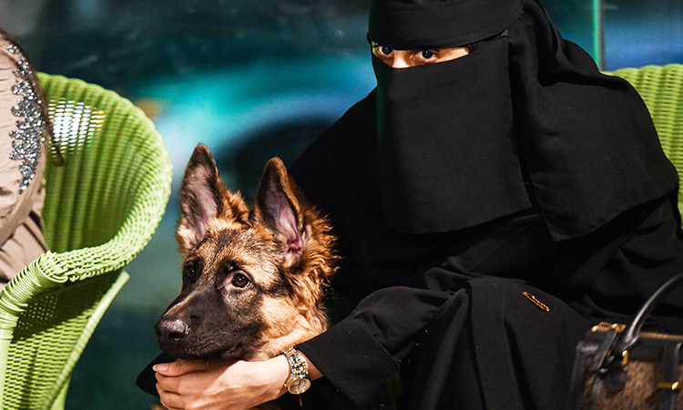 a girl holds her dog at the barking lot cafe in saudi arabia s eastern gulf city of khobar afp