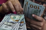 a teller counts us dollar bank notes at a money changer in jakarta indonesia photo reuters file