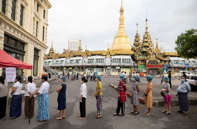 people wearing face masks wait to cast their ballots for the general election at a polling station in yangon myanmar november 8 2020 reuters